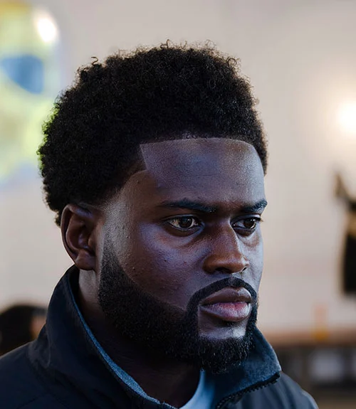 Professional afro fade with groomed beard for Black men